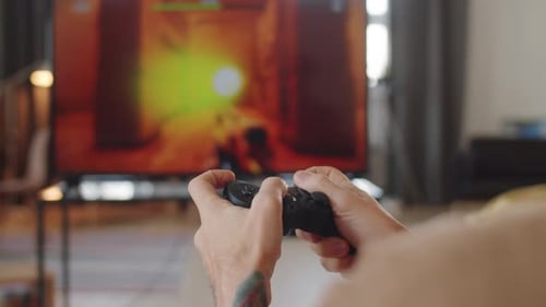 Hands Playing Video Game With Controller at Home