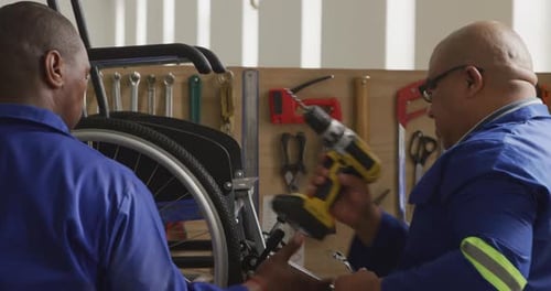 Workers making a wheelchair