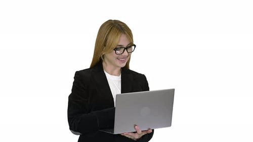 Smiling Young Woman Working at Laptop