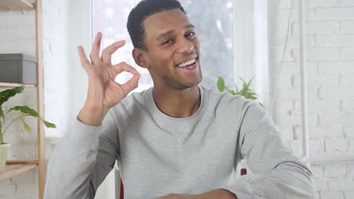 Happy Man Gives Okay Sign Indoors
