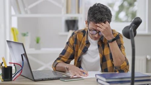 Student Studies at Desk With Laptop and Books