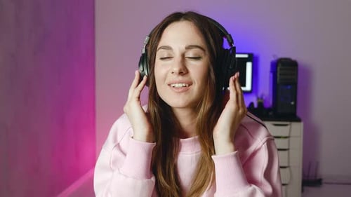 Woman Listening Music on Headphones at Home Neon Background