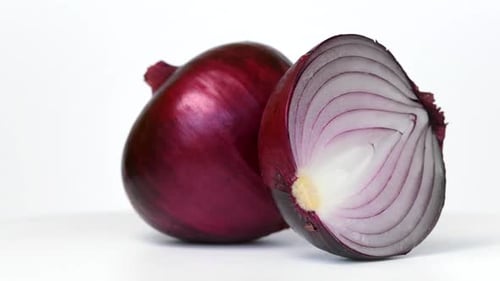 Red onion rotating on white background