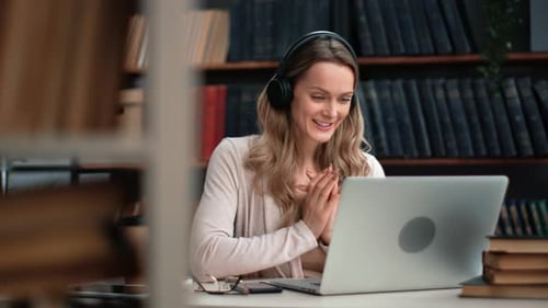 Woman in Headphones Talking Online Video Call Use Laptop e Learning Distance Education Library Desk