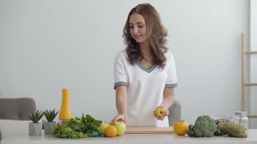 Young Woman with Fresh Produce in Bright Kitchen