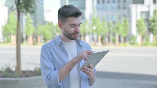 Man Using Tablet Device in Urban Environment