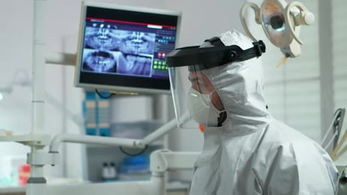Medical Professional in Protective Suit Explains X-Rays