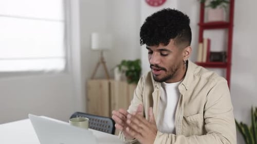 Young Adult Man Talking on Laptop Video Call