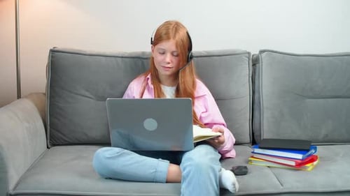 Red Haired Student Studying at Home with Laptop