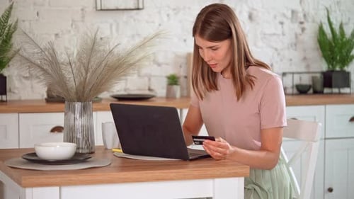 Woman Using Laptop for Online Shopping at Home