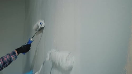 Two Person Paint the Wall with Painting Rollers