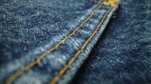 Macro Detail of Blue Denim Fabric and Stitching