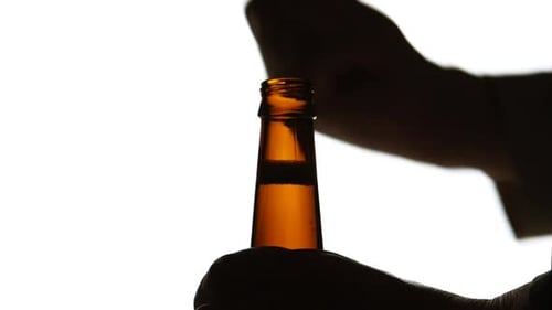 Brown Glass Bottle Cap Being Removed