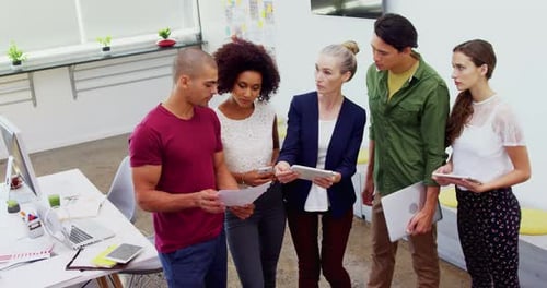 Team of Adults Collaborating on Project in Office