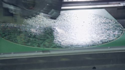 Close up of SMT Machine placing components on a circuit board