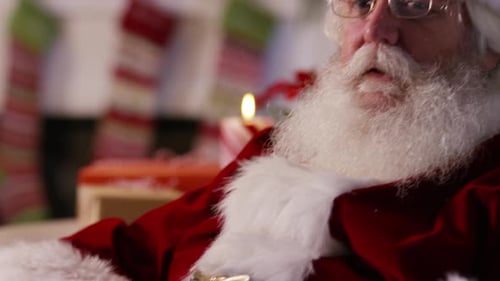 Senior Man Dressed as Santa Adjusting Glasses