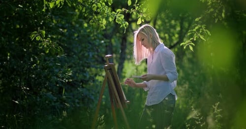 Woman Painting Art on Canvas Outdoors