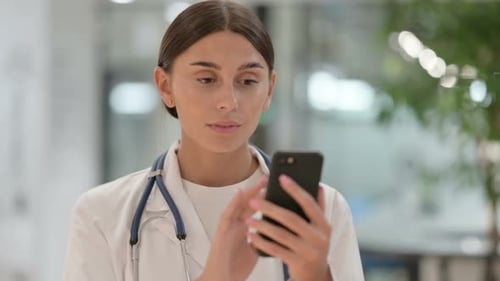 Young Female Doctor Using Mobile Phone