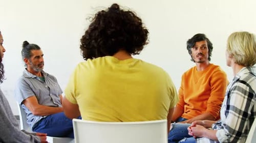 Adults Sitting in a Circle Discussing Issues