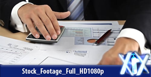 Man Calculates Financial Reports in an Office