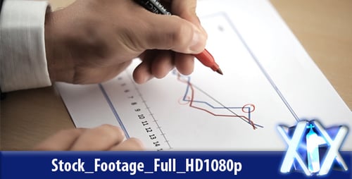 Hand Annotates Financial Data on Line Graph