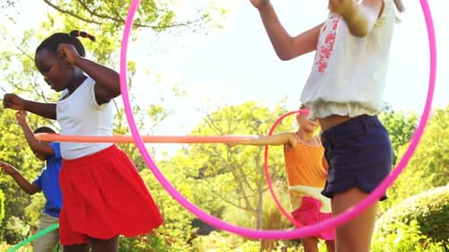 Children Having Fun Playing With Hula Hoops