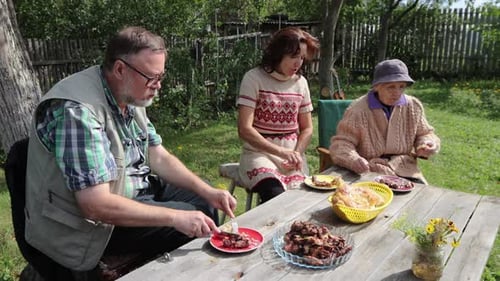 Friends and Family Enjoying Outdoor Meal
