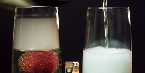 Champagne Poured Next to Strawberry Cocktail