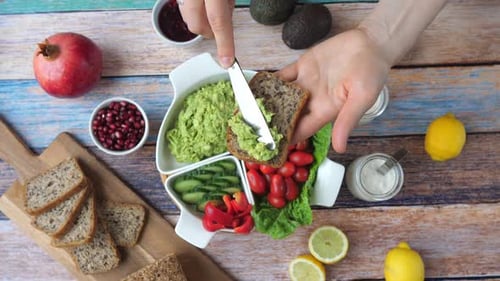 Hands Preparing Avocado Toast with Fresh Ingredients