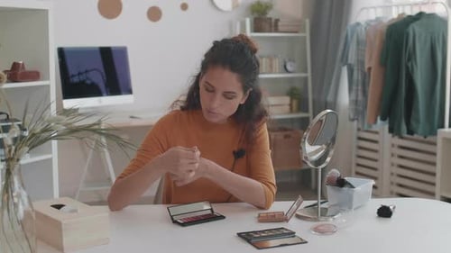 Woman Demonstrates Makeup Application in Home Setting