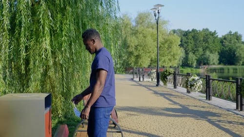 Happy Man in Park Showing Arm After Vaccine