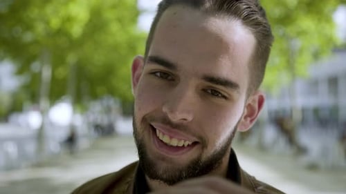 Happy Young Man Smiling on City Street