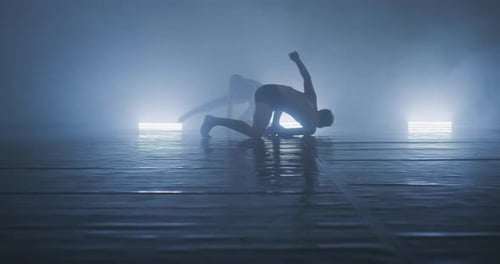 Couple Preforming Art or Contemporary Dance in Room Filled with Smoke