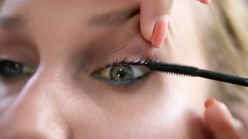 Applying Mascara to Eyelashes in Extreme Close Up