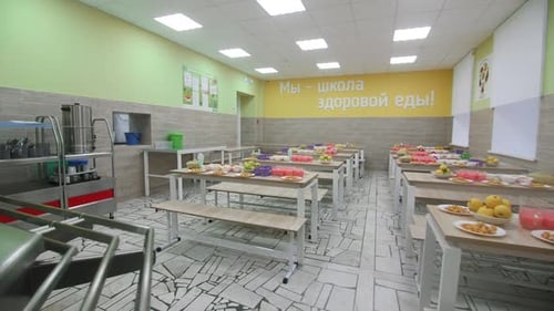 Tables with Healthy Dinner for Students in School Canteen