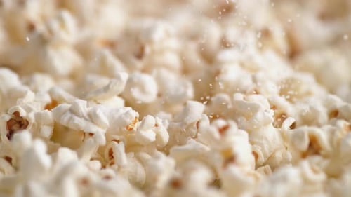 Sprinkling salt on popcorn. Slow Motion.