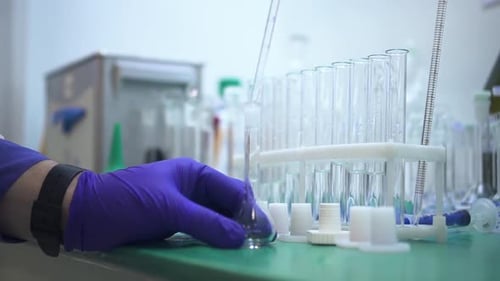 Man Chemist is Working with Chemicals at Table in Pharmaceutical Laboratory Spbd