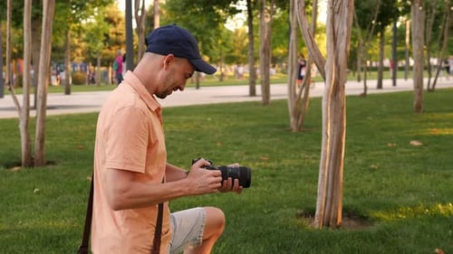 Closeup Male Photographer in the Park in Summer He Photographs Family