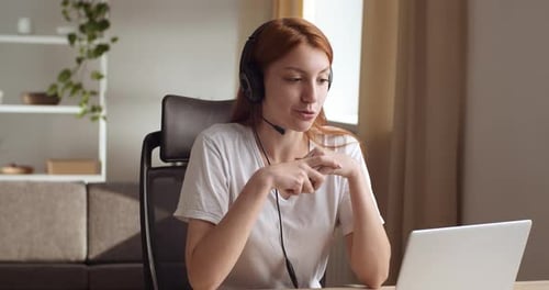 Woman Video Calling Using Laptop in Home Office