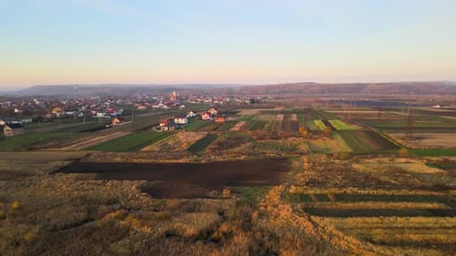 Aerial view of private homes in rural suburban area at sunset.