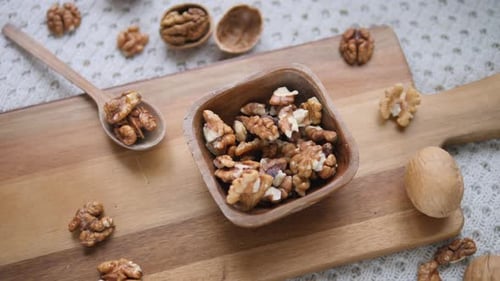 Healthy Food. Walnuts In Wooden Bowl On Wooden Board. Top View.