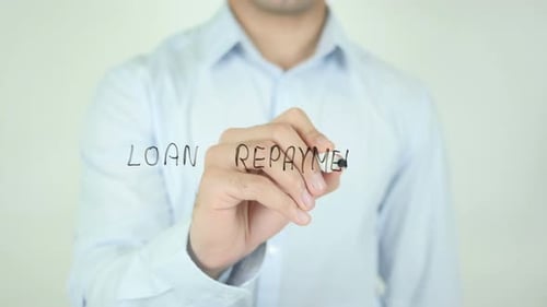 Man Writing Loan Repayment with Marker