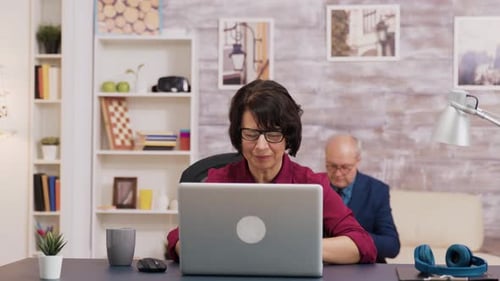Woman Working On Laptop at Home