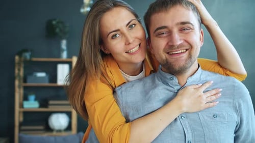 Affectionate Couple Smiling, Embracing, and Kissing