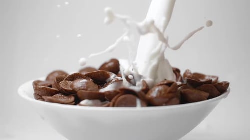 Milk Pouring into Bowl of Chocolate Cereal