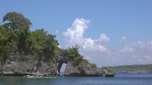 Arch in the Sea Rock and Clouds
