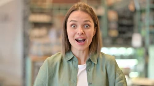 Woman Reacts with Surprise and Then Celebrates