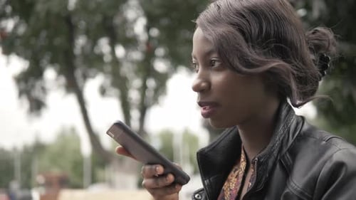 Woman Using Smartphone in Urban Setting