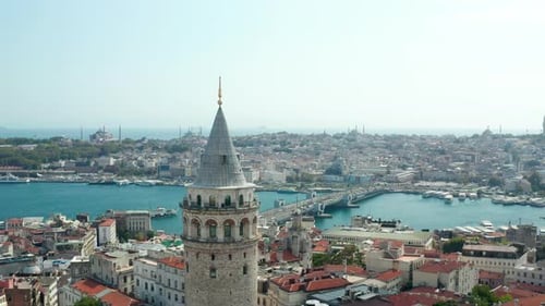 Passing Galata Tower Revealing Galata Bridge Over Bosphorus with Beautiful Clear Blue Sky, Slow