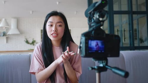 Young Woman Recording Video Blog At Home